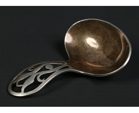 An Arts and Crafts silver caddy spoon with open fretwork handle. Assayed Sheffield 1944, 21.2 grams.  Condition Report. To be