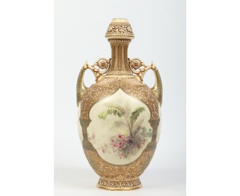 A large Royal Worcester twin handled vase. With moulded stylized floral grounds in the Persian style and enamelled with flowe