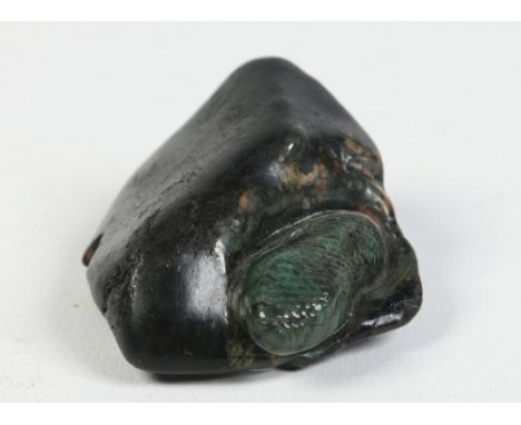 A Jade carving, possibly Maori and depicting a snake emerging from a hole, 5.5cm. Condition Report. To be used as a guide onl
