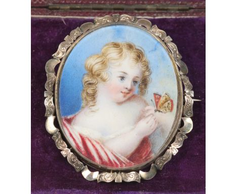 A Victorian yellow metal brooch in fitted case. With scrollwork frame and set with an ivory portrait miniature of a young gir