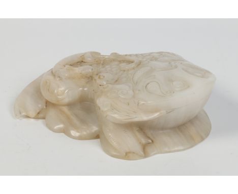 A Chinese white jade model of a toad crouching upon ruyi branches and with a small lizard perched on its back, 25cm. Conditio