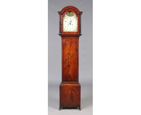 A Regency mahogany eight day longcase clock. With painted arch top dial incorporating subsidiary seconds and striking on a be