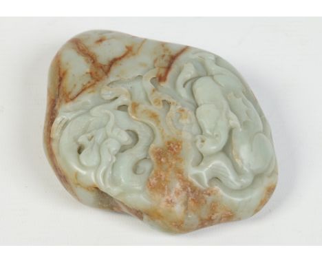 A Chinese carved celadon jade boulder. Decorated in relief with a horse and dragon, 13cm. Condition Report. To be used as a g