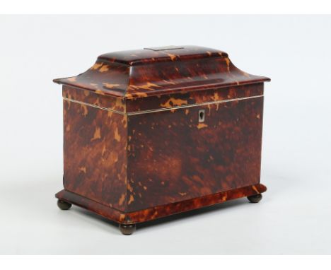 A Regency tortoiseshell tea caddy with pagoda top, two compartments and raised on brass ball feet, 20cm wide. Condition Repor