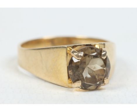 A 9 carat gold ring set with a brilliant cut smokey quartz stone. London 1975, size N, 3.6 grams. Condition Report. To be use