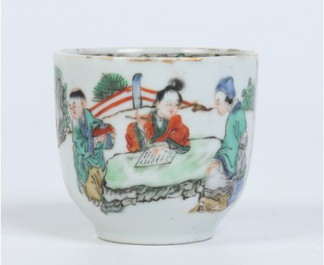 An antique Chinese coffee cup with scrolling handle ornamented with two spurs. Painted in famille vert enamels with figures c