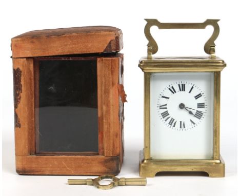 A nineteenth century French brass carriage clock in travelling case.  With enamel dial, Roman numeral markers and housing a s
