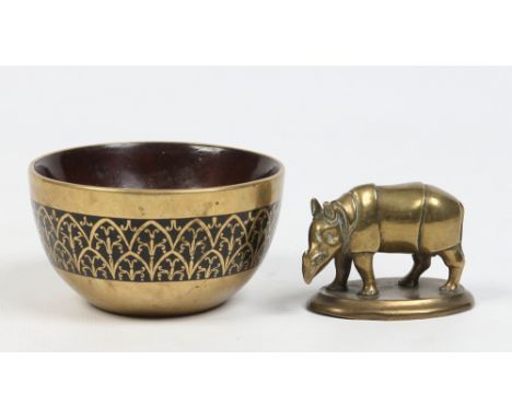 An Indian brass inlaid coconut cup and a brass model of a rhinoceros. Bowl 8.5cm diameter.   Condition Report. To be used as 