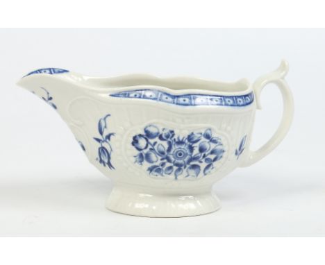 A Worcester strap fluted sauceboat painted in underglaze blue with flowers. Crescent mark c1775, 17cm. Condition Report. To b
