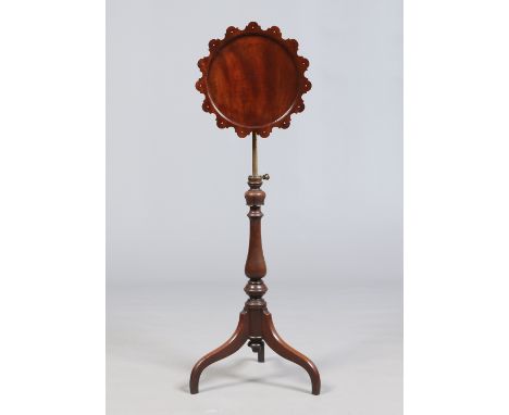 A Victorian mahogany rise and fall centre pedestal snap top lamp table. With Gothic revival scalloped top and raised on a tri