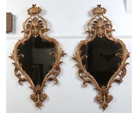 A pair of Chippendale revival gilt wood pier mirrors, twentieth century. With shell moulded finials and leaf scroll mouldings