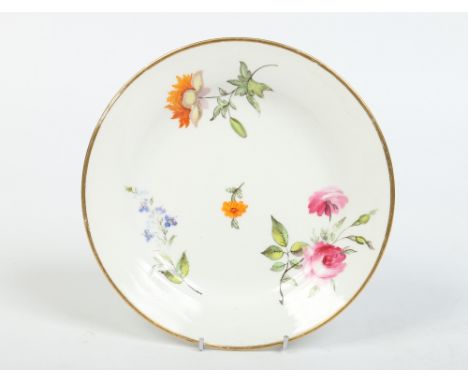 An early nineteenth century Swansea plate. Brightly painted with flower sprays under a gilt banded rim. Impressed mark, 20.25