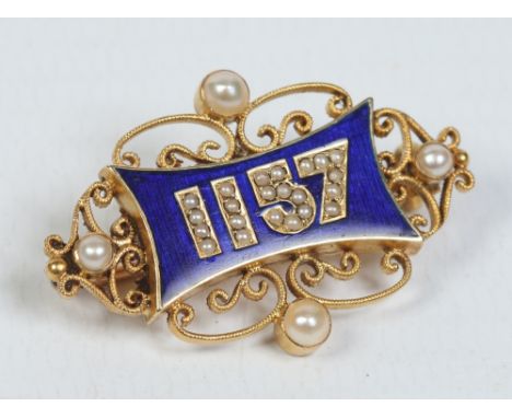 An Edwardian 18 carat gold brooch in memoration of the 1907 Hexham by-election. With blue enamel ground and set with seed pea