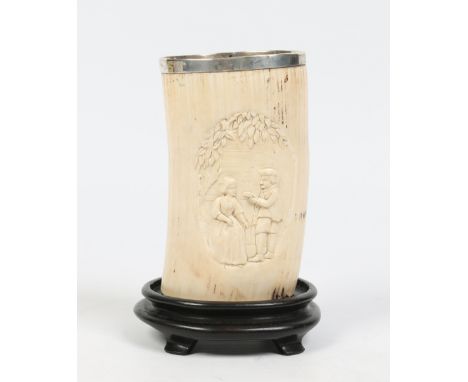 A European ivory tusk vase with silver rim and glass bottom. Carved with two cartouches depicting figures in landscapes, 16cm