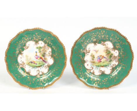 A pair of Royal Worcester cabinet plates. With moulded gardrooned rims, gilded over apple green ground borders and enamelled 
