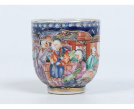 An eighteenth century Chinese coffee cup with European gilding. Ground in underglaze blue with flowers and lotus scrolls and 