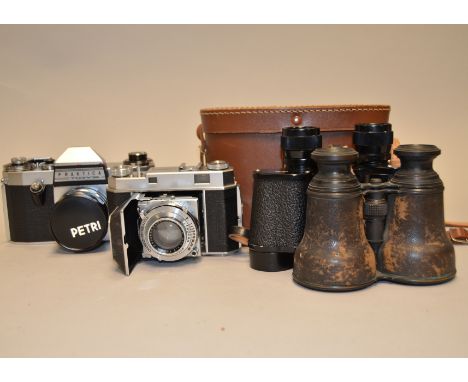 A Kodak Retina II 35mm Camera, with Rodenstock Heligon f/2 5 cm lens, shutter working, together with a Praktica Nova SLR came