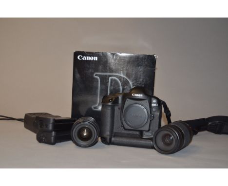 A Canon EOS-1D DSLR Camera and Lenses, serial no 020025, body G, slight wear around flash shoe and base, powers up, a Canon E