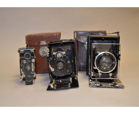 A Group of Three Folding Cameras, a Wallace Heaton New Universal Zodel 6.5 x 9cm folding-bed plate camera with a Zodellar  f/