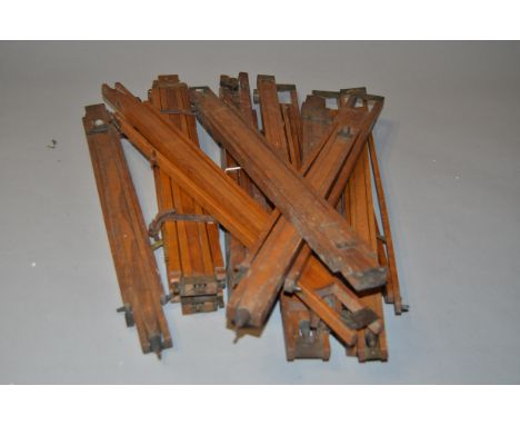 A Quantity of Individual Polished Wooden Legs, possibly easel or tripod legs with brass clamps and spacers, contained in a da
