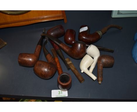 An array of vintage traditional pipes, names such as Carey Magic inch,Bari Ruby etc, some clay bowls too.