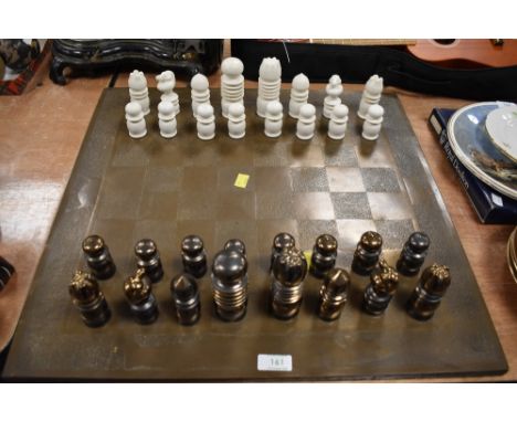 An unusually designed chess set with Bauhaus or art deco design ceramic with white and lustre glazes and brass style games bo