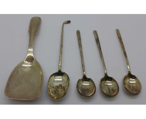 A Georg Jensen silver caddy spoon, London import mark for 1928, a silver golf teaspoon and three silver coffee spoons, 48.7g 
