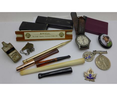 A silver and enamel fob medal and badge, cigarette holders, a WWI British War medal to 7745 Pte. T.W. Gee, E. York R., etc., 