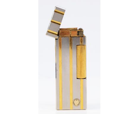 Dunhill, a stainless steel and gold plated rollagas lighter, serial number 40028, case