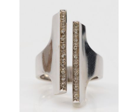 A white gold diamond ring, two rows of single cut diamonds to a modernist style cuff ring, front measures 26mm, stamped 750 t