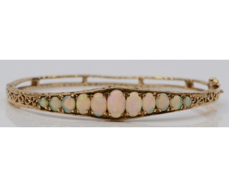 A 9ct gold and graduated opal hinged bangle, Birmingham, c.1980, 58 x 51mm internal, 12gmOverall condition is good, stones ar