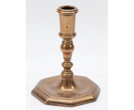 A mid 17th century bronze candlestick, with octagonal base, 14cm