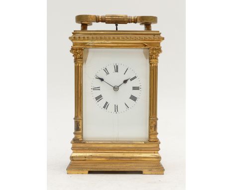 A French 19th century brass repeating and striking carriage clock, white enamel dial, the movement striking the hours and hal