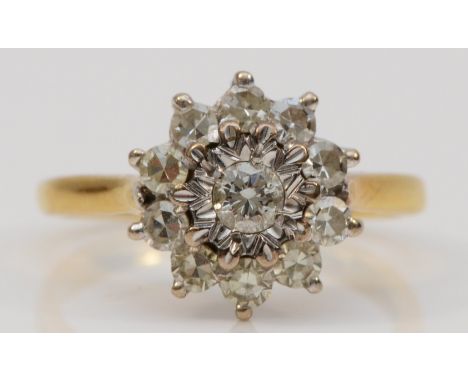 An 18ct gold gold and diamond cluster ring, Birmingham 1976, illusion set with a brilliant cut stone bordered by single cuts,