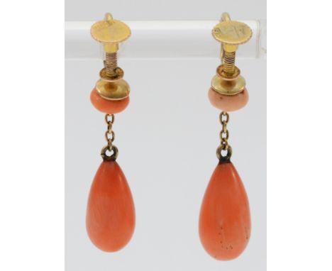 A pair of 9ct gold Victorian coral screw fitting earrings, 5mm coral button with a gold chain that hangs a 12mm coral pear, t
