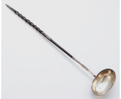 A George III silver and whalebone ladle, London 1972, with bright cut engraved decoration, 38cm