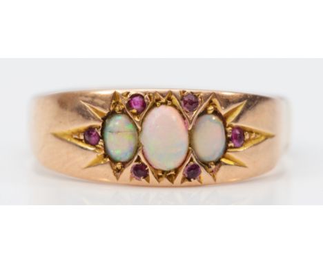 A 9ct rose gold vintage opal and ruby dress ring, three opals with the largest being 5mm, R 1/2, 2.5g