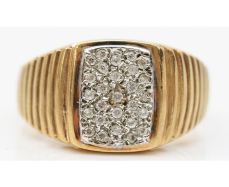 A 9ct gold brilliant cut diamond faced signet ring, stepped detailing to the shoulders, London 1985 with a makers mark DT, V,