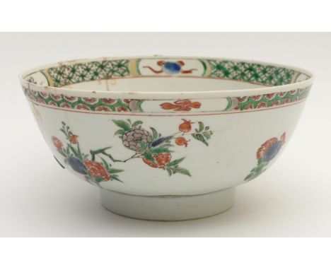 A Chinese Kangxi period famile verte bowl, with blue flower head mark, with floral decoration, 19th century staple repairs, d