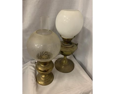 TWO BRASS OIL LAMPS, AN ETCHED GLASS LAMP SHADE AND FURTHER MILK GLASS SHADE 