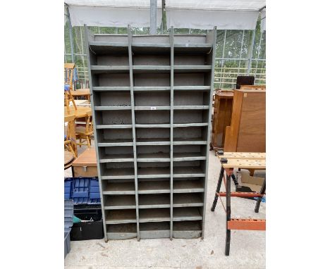 A 36 SECTION METAL PIGEON HOLE STORAGE UNIT 