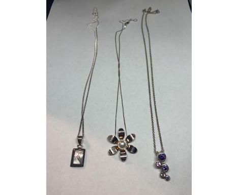 THREE MARKED SILVER NECKLACES WITH PENDANTS TO INCLUDE A PAERLISED RECTANGLE, A FLOWER WITH CENTRE PEARL AND A PINK AND PURPL