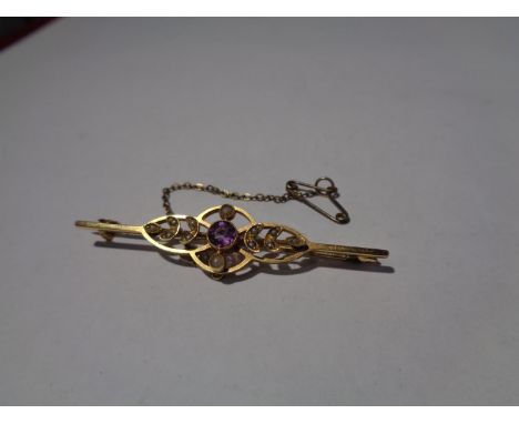 A TESTED TO 9 CARAT GOLD BROOCH WITH PEARL AND COLOURED STONE DESIGN GROSS WEIGHT 4 GRAMS 