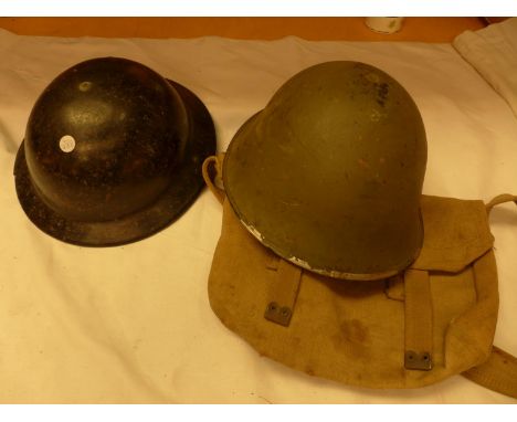 A WORLD WAR II BLACK PAINTED BRITISH BAKELITE HELMET, FURTHER GREEN PAINTED HELMET AND A CANVAS BAG (3) 