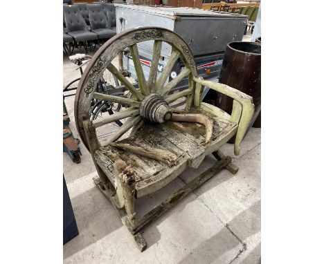 A VINTAGE WOODEN GARDEN BENCH WITH CART WHEEL BACK 