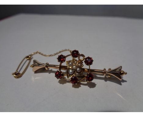 A MARKED 15 CARAT GOLD BROOCH WITH PEARL AND REDSTONE DECORATION GROSS WEIGHT 4.4 GRAMS 