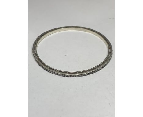A SILVER BANGLE WITH DIAMOND CHIPS (SOME MISSING) 