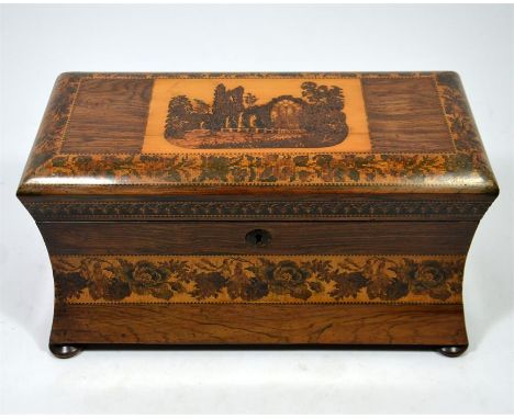 A rosewood Tunbridge ware tea caddy with a view of Muckross Abbey, contains two lids and engraved mixing bowl. Circa 1870. He