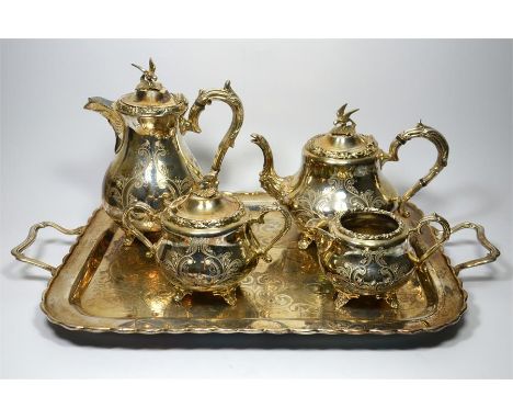 An early 20th century silver plated five piece tea set, with a floral decoration and finial shaped as a bird, includes a teap