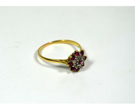 A seventeen stone ruby and diamond cluster ring, eight round rubies surrounding eight diamonds with a ruby centre stone. Moun